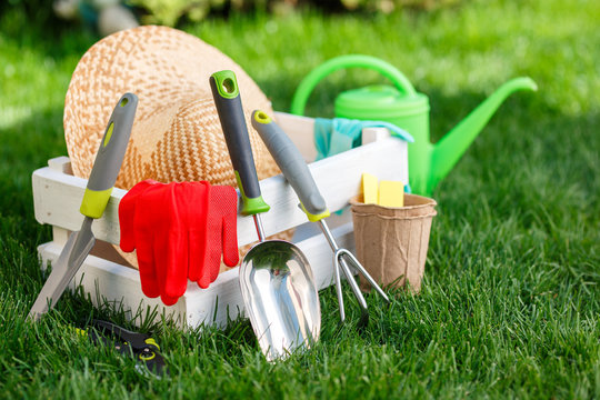 Gardening tools and utensils on green meadow, garden manteinance and hobby concept