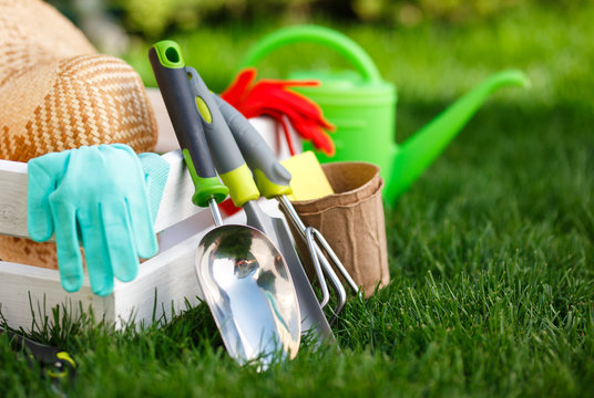 Gardening tools and utensils on green meadow, garden manteinance and hobby concept