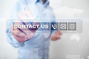 Contact us button and text on virtual screen. Business and technology concept.