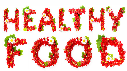 word HEALTHY FOOD is written and collected from red currant berries on a white background is isolated