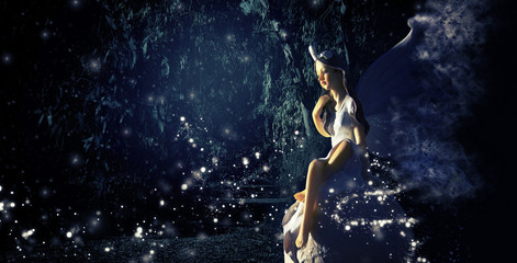 Fototapeta na wymiar image of magical little fairy in the forest sitting over the stone.