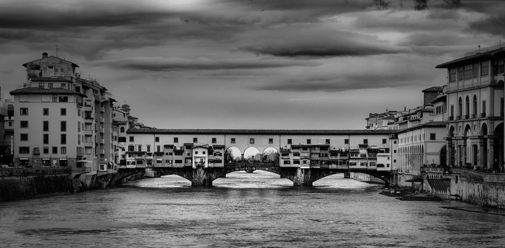 Fototapeta Beautiful black and white photo of the Ponte Vecchio, a medieval stone arch bridge over the Arno River, in Florence, Italy.