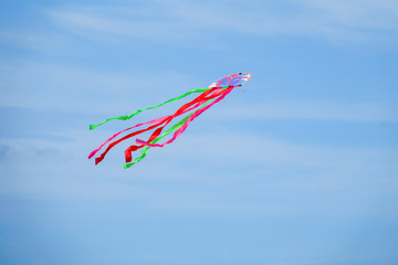 Colourful kite over  the blue sky.