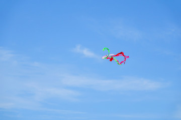 Colourful kite over  the blue sky.