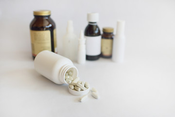 Vitamins, pills in a white plastic bottle on a white background. Against the background of drugs