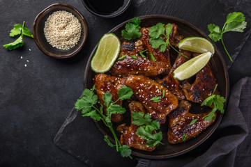 teriyaki chicken wings, served with lime, cilantro and sesame seeds
