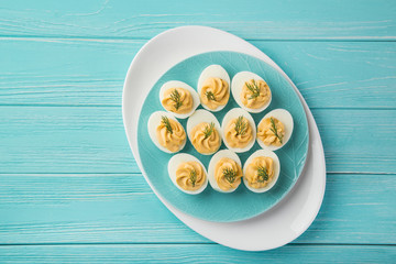 stuffed eggs on blue plate for easter table - Powered by Adobe