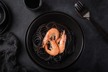 squid ink spaghetti pasta with prawn in black bowl
