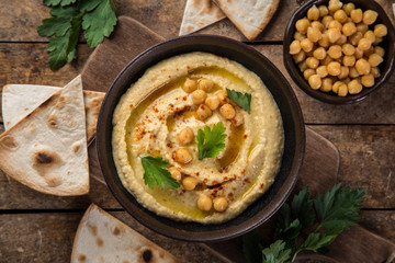 healthy homemade chickpea hummus with olive oil and smoked paprika,