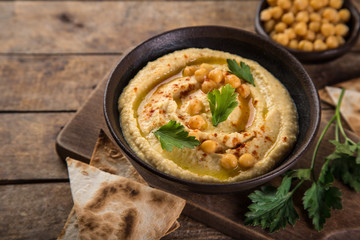 healthy homemade chickpea hummus with olive oil and smoked paprika,
