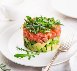 delicious avocado and salted salmon tartar, served with arugula