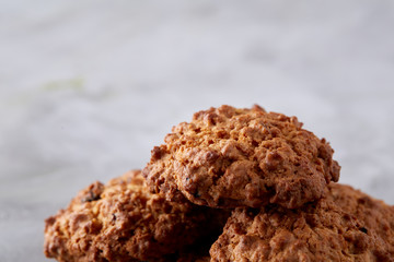 Sweet biscuits arranged in pattern on light textured background, close-up, shallow depth of field, selective focus.