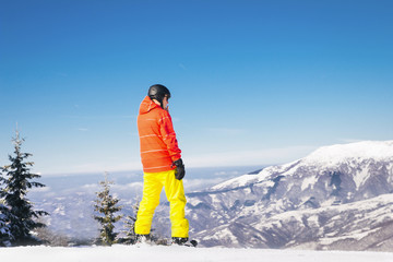 Fototapeta na wymiar Snowboarder standing in mountains
