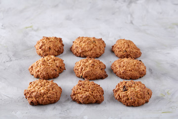 Sweet biscuits arranged in pattern on light textured background, close-up, shallow depth of field, selective focus.