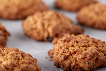 Sweet biscuits arranged in pattern on light textured background, close-up, shallow depth of field, selective focus.