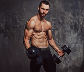 Brutal athletic bearded shirtless male doing exercise with dumbb