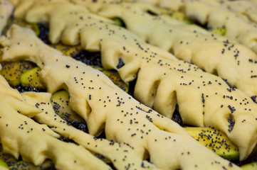 raw homemade rustic pie with apples, poppy seeds and jam