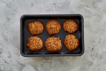 Fresh baked chocolate cookies on a cookie sheet, top view, close-up, selective focus
