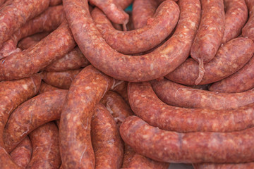 pile of raw sausages ready to cook or grill