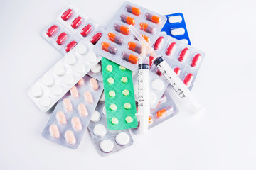 syringe and pills isolated on white