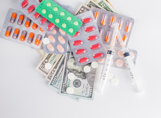 money and pills isolated on white