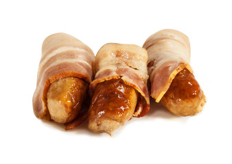 Fried sausages wrapped in bacon on white isolated background.