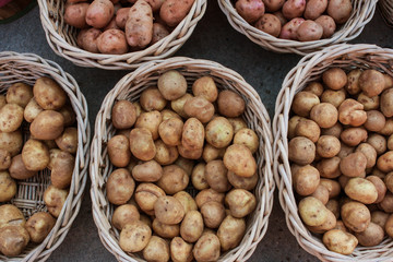 Groups Of Potatoes Sit In Baskets At Farmers Market