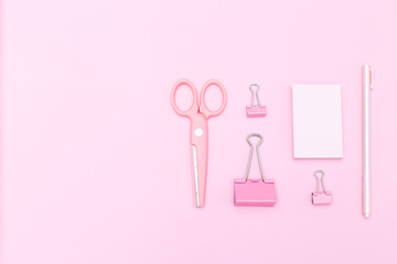 Pink stationery on pasrel background. Copy space
