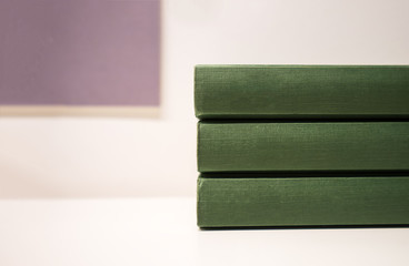 green books stack on table in library room and free copy space for edit