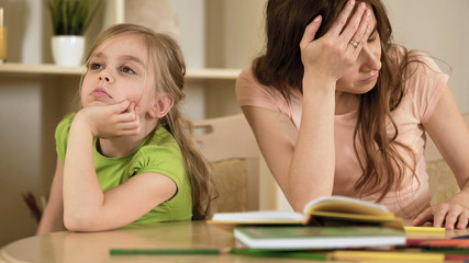 Upset mother is angry to little bored daughter, homeschooling, misunderstanding