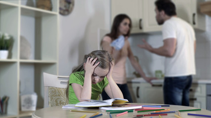 Upset child listening divorcing parents fight, suffering from conflict in family