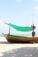 The wooden fishing boat on the beach.