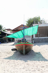 The wooden fishing boat on the beach.