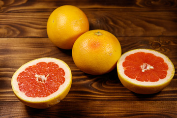 Ripe fresh grapefruits on wooden table