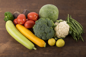 Vegetable:  Close up of Yellow Zucchini, Bottle Gourd, Winter Melon, Lemon Cauliflower ,French Beans, Tomatoes, Beet Root And Green Bell Pepper On Wooden Background Shot In Studio.