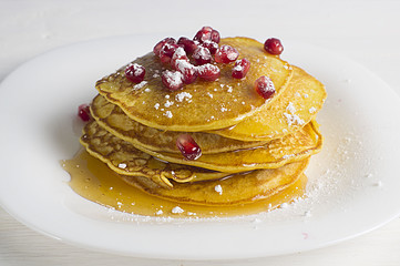 Pancakes with honey and pomegranate seeds