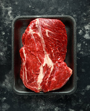 Fresh Raw braising steak on black tray