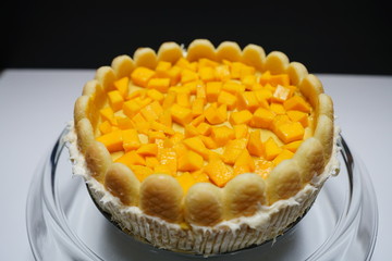 Homemade mango cake with cookies around the edge. 