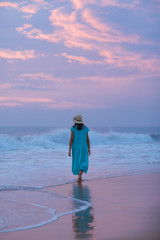 Woman at the seashore of Indian ocean after sunset