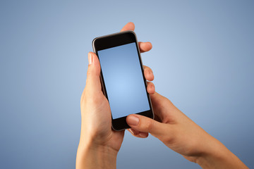 Female hand holding smartphone