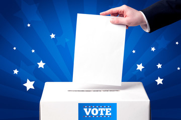 hand with ballot and wooden box