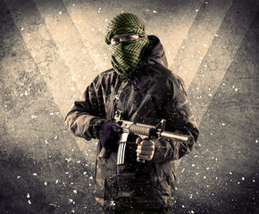 Portrait of a dangerous masked armed soldier with grungy background