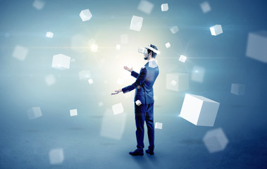 Businessman with vr goggle and falling cubes