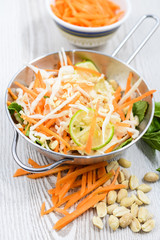 Vietnamese carrot salad on rustic wooden table. Traditional Vietnamese cuisine.