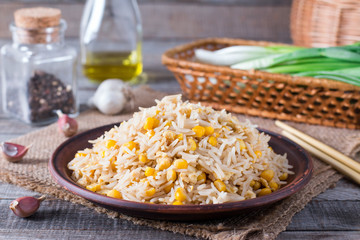 Fried rice with egg and corn close-up on a plate, horizontal