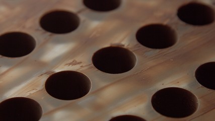 empty mold of chocolate candys closeup of holes