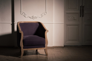antique violet oak armchair in the dark interior