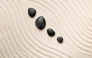 Fototapeta na wymiar Zen sand and stone garden with raked curved lines. Simplicity, concentration or calmness abstract concept