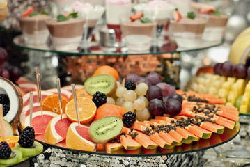 Vegetables and fruits are well-cut on a buffet