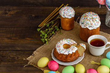 Easter cake and colorful eggs on a wooden table. It can be used as a background
